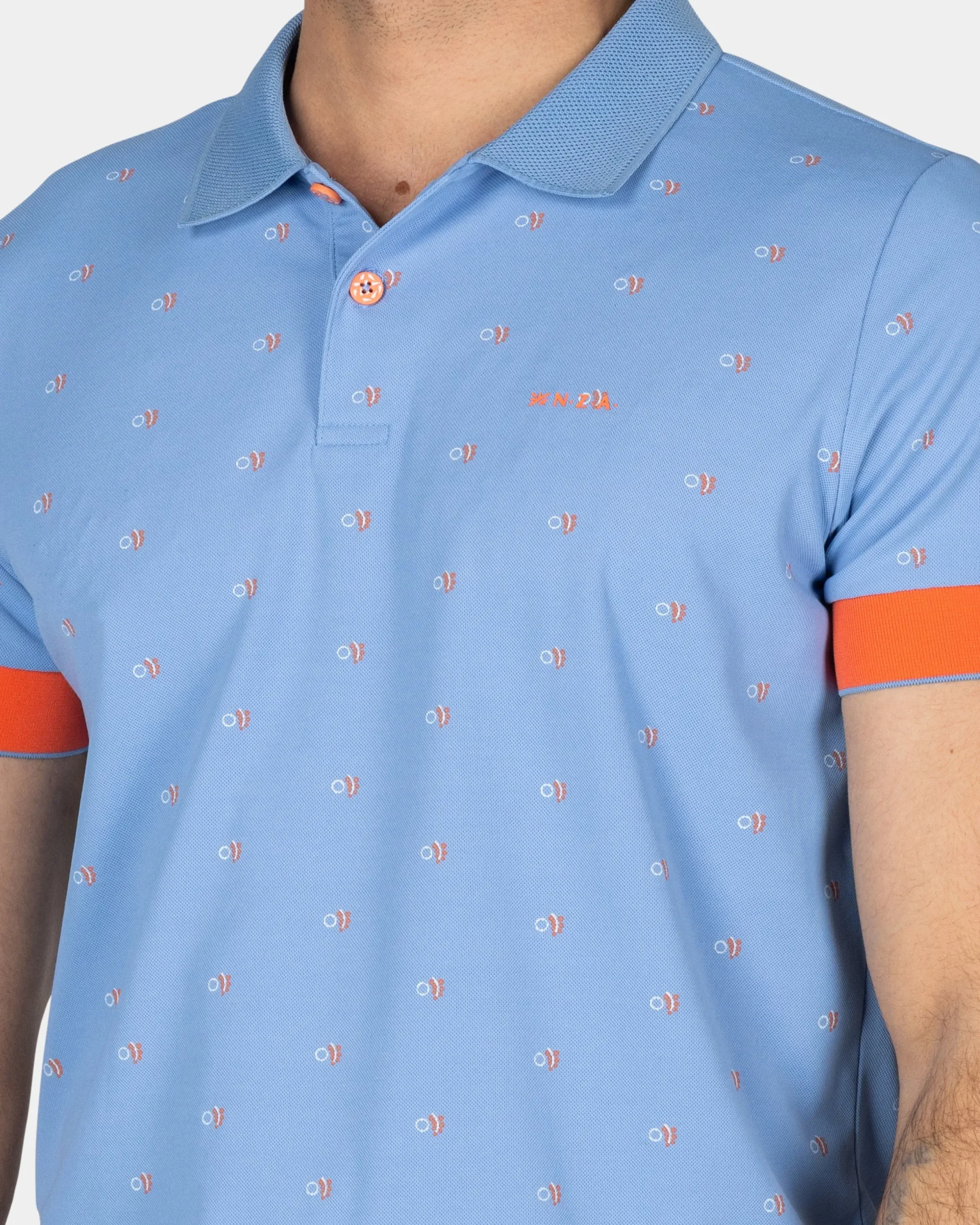 NZA New Zealand Auckland Lichtblauwe polo met oranje accenten
