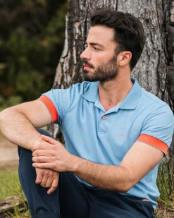 NZA New Zealand Auckland Lichtblauwe polo met oranje accenten